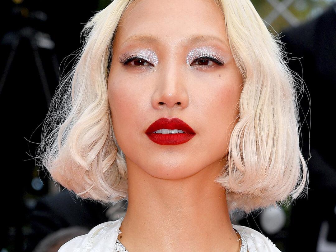 Close-up of a glam Soo Joo Park rocking shimmery silver eyeshadow and bold red lips Desktop