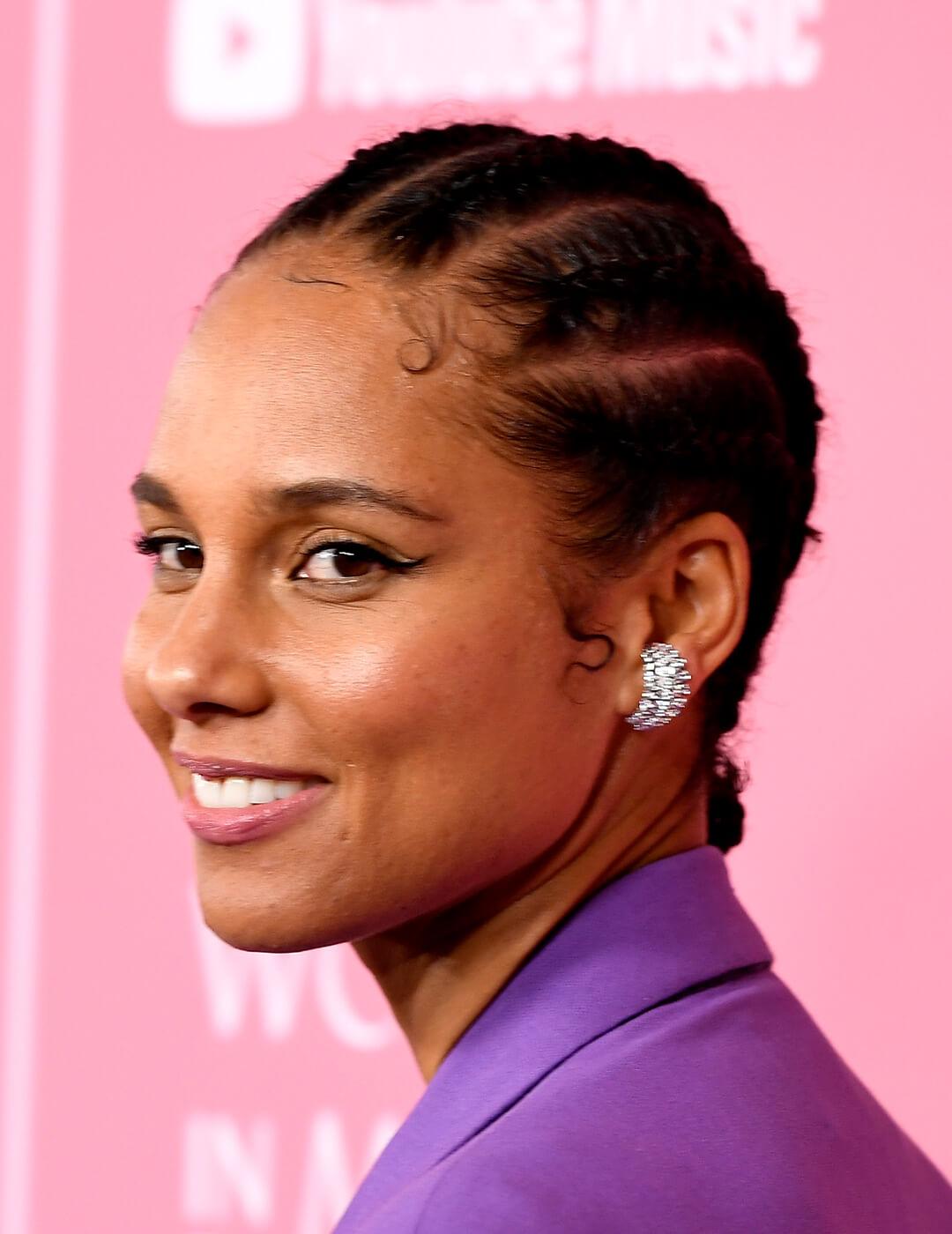 Alicia Keys in a purple suit rocking her cornrows Mobile
