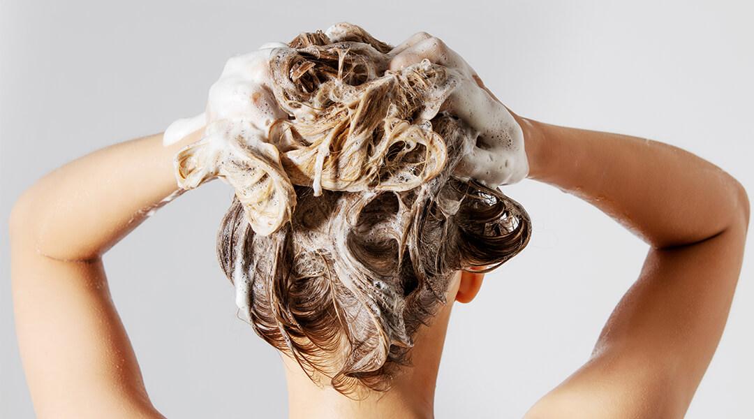 Woman shampooing her hair Desktop