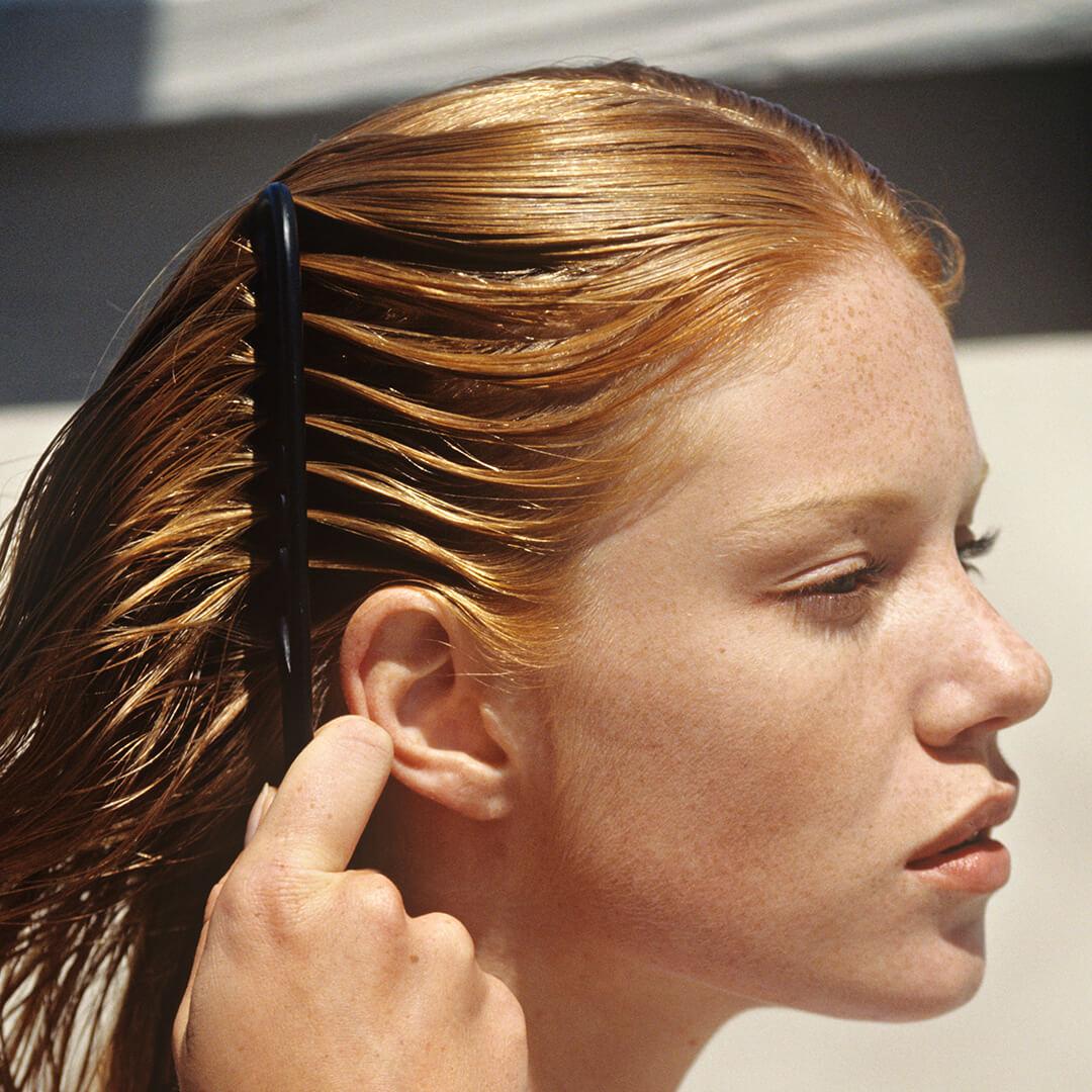 A photo of a woman combing her hair Mobile