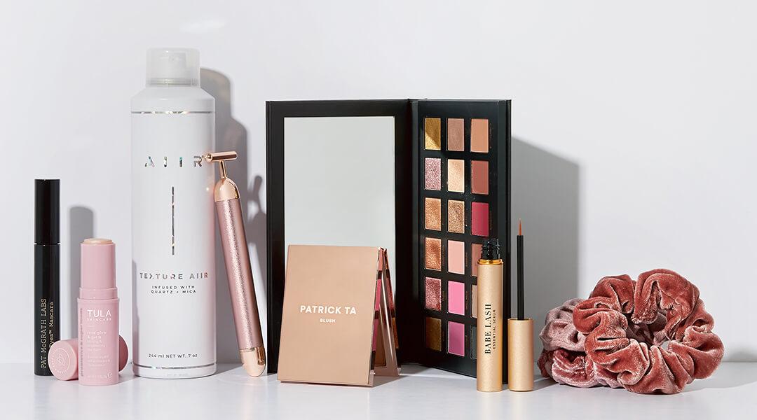 Flat lay image of makeup, hair care, and skincare products on white background Desktop