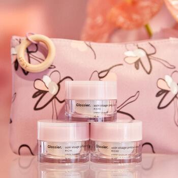 An image of three GLOSSIER Priming Moisturizer Rich stacked in front of the April Glam Bag Mobile