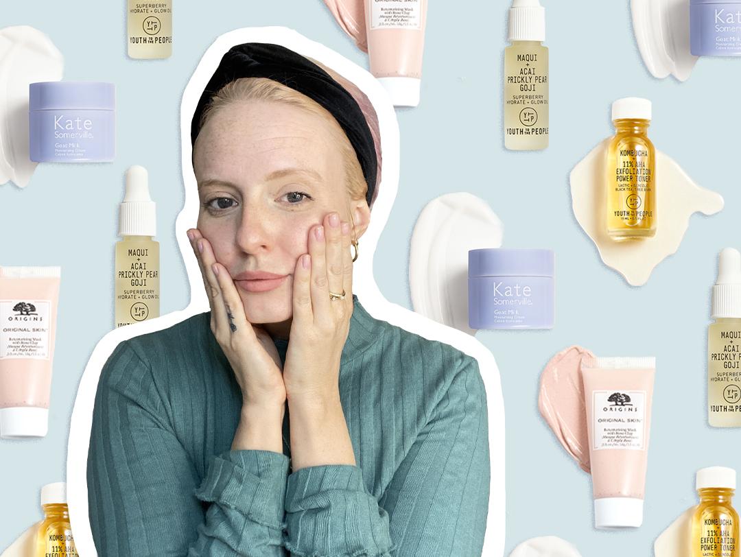 Hannah Cassidy in a green sweatshirt and black headband touching her cheeks with her two hands against skincare products swatches background Desktop
