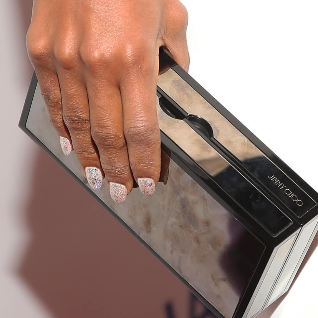 Close-up of Kerry Washington's hands with glitter nails holding her purse Mobile