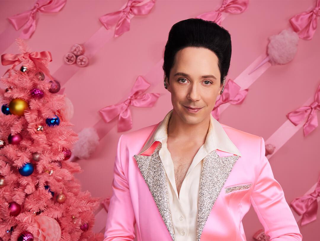Portrait of Johnny Weir in a sparkly, pink satin suit against pink background with pink bows and pink Christmas tree Desktop