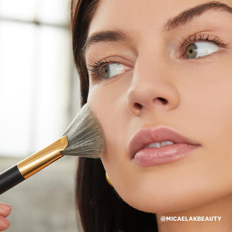 An image of a model using a fan brush in applying contour makeup Desktop