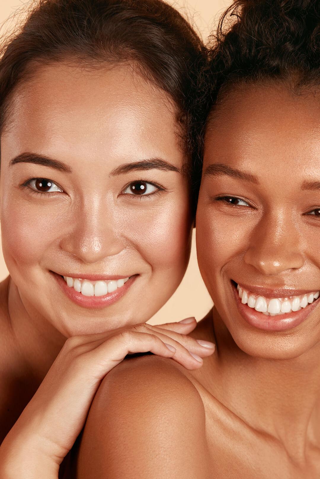Beauty shot of two smiling young women with clear skin Desktop