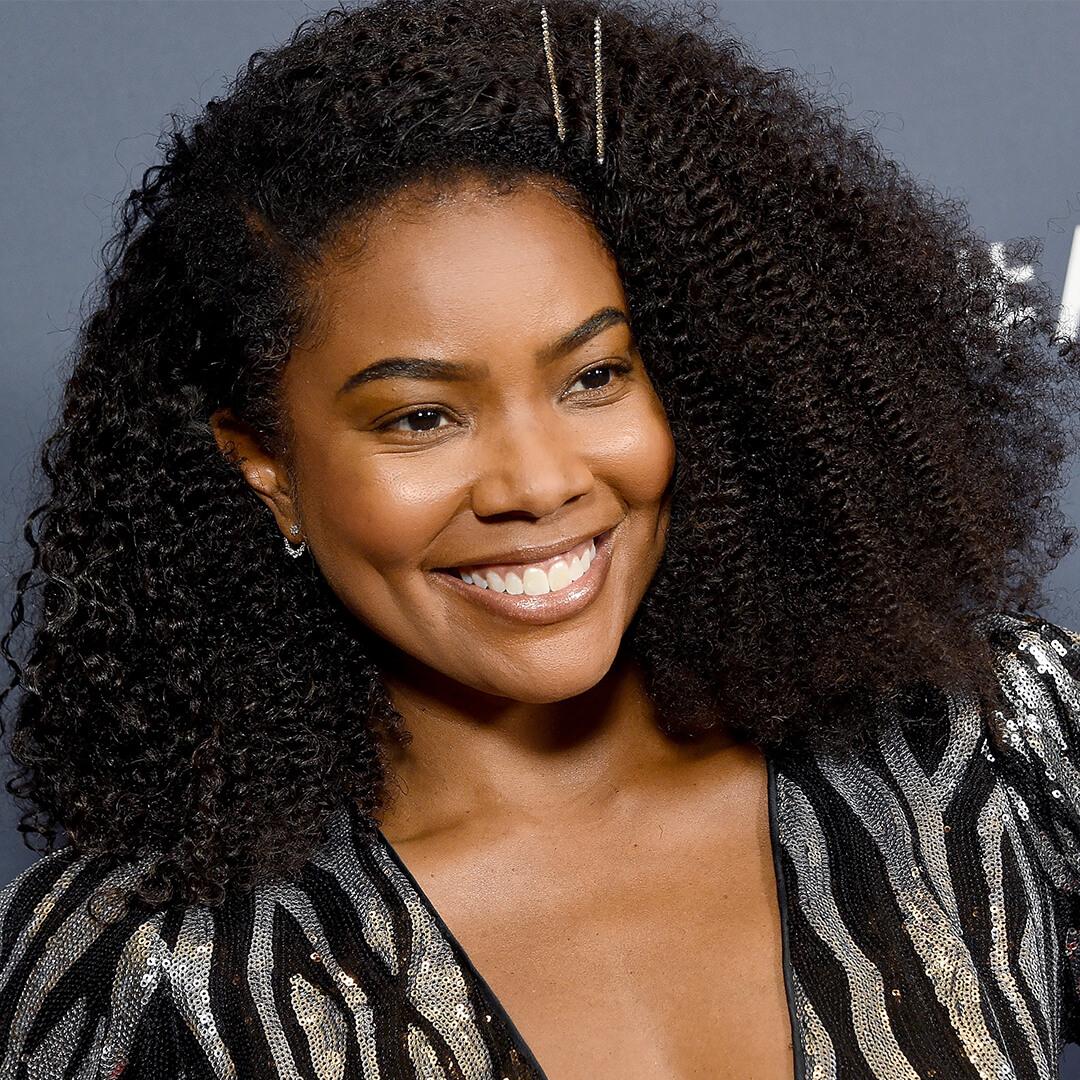 Gabrielle Union in a black and silver sequined dress rocking her pinned back natural curls while smiling Desktop