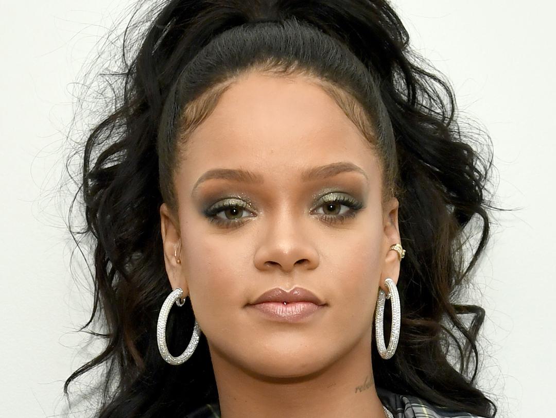 A photo of Rihanna with smokey eye makeup with silver hoop earrings Desktop