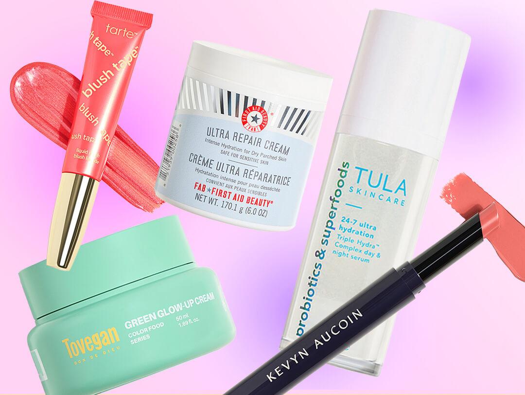 Skincare and makeup products from various brands on colorful background Desktop