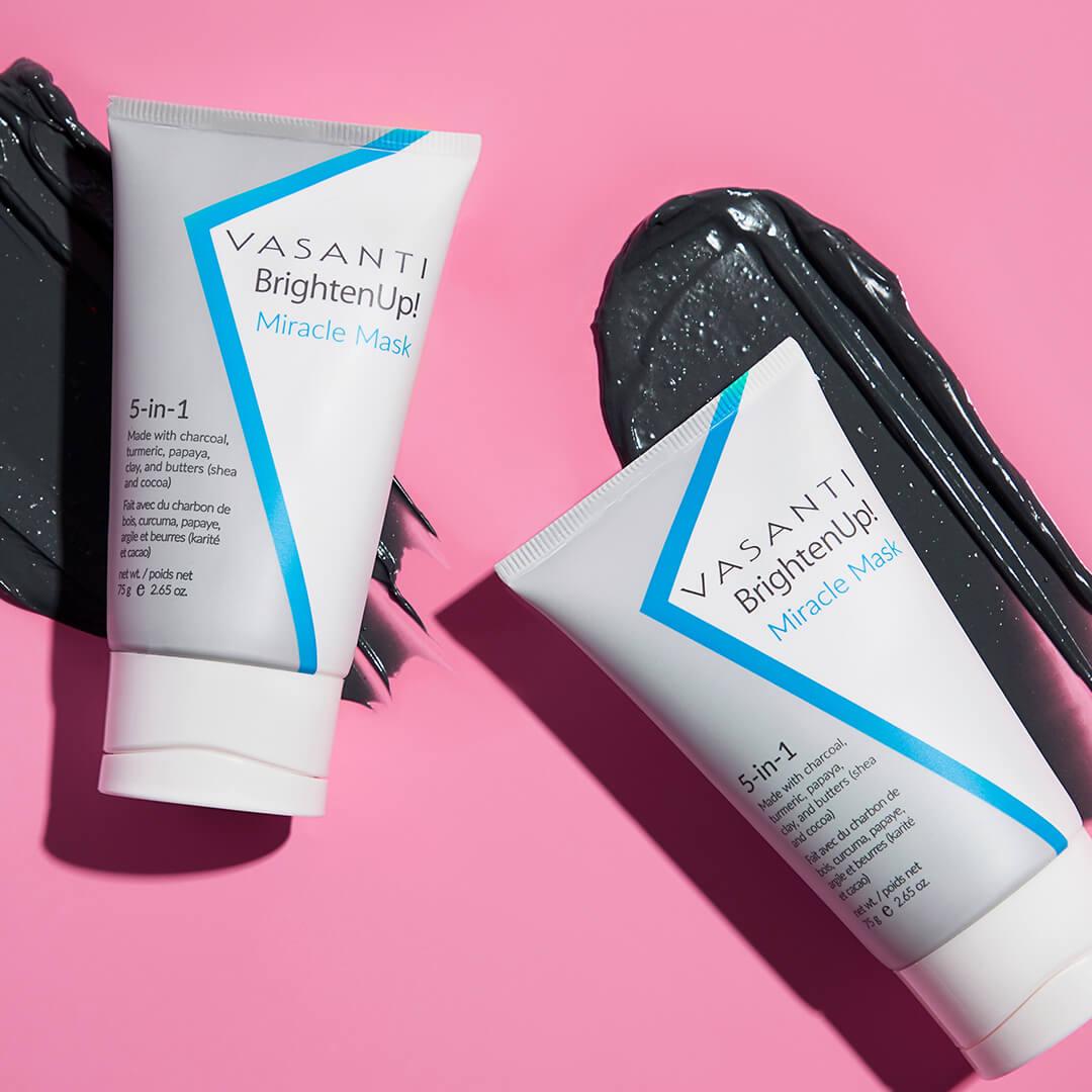 Image of two tubes of VASANTI COSMETICS Brighten Up! Miracle Mask 5 in 1 swatched on pink background Mobile