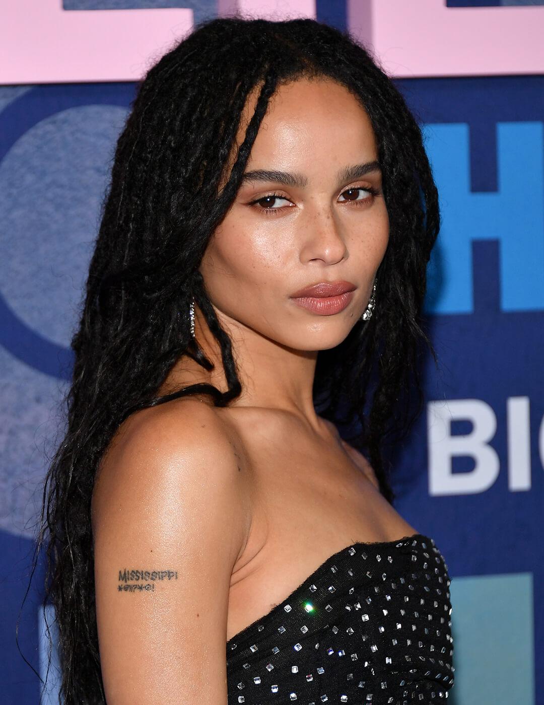 Zoë Kravitz rocking a loose braided hairstyle and black sequined dress on the red carpet Mobile