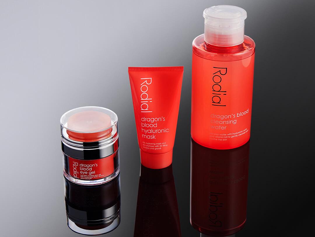 RODIAL Dragon’s Blood Eye Gel, RODIAL Dragon’s Blood Hyaluronic Mask, and RODIAL Dragon’s Blood Micellar Cleansing Water on dark reflective background Desktop
