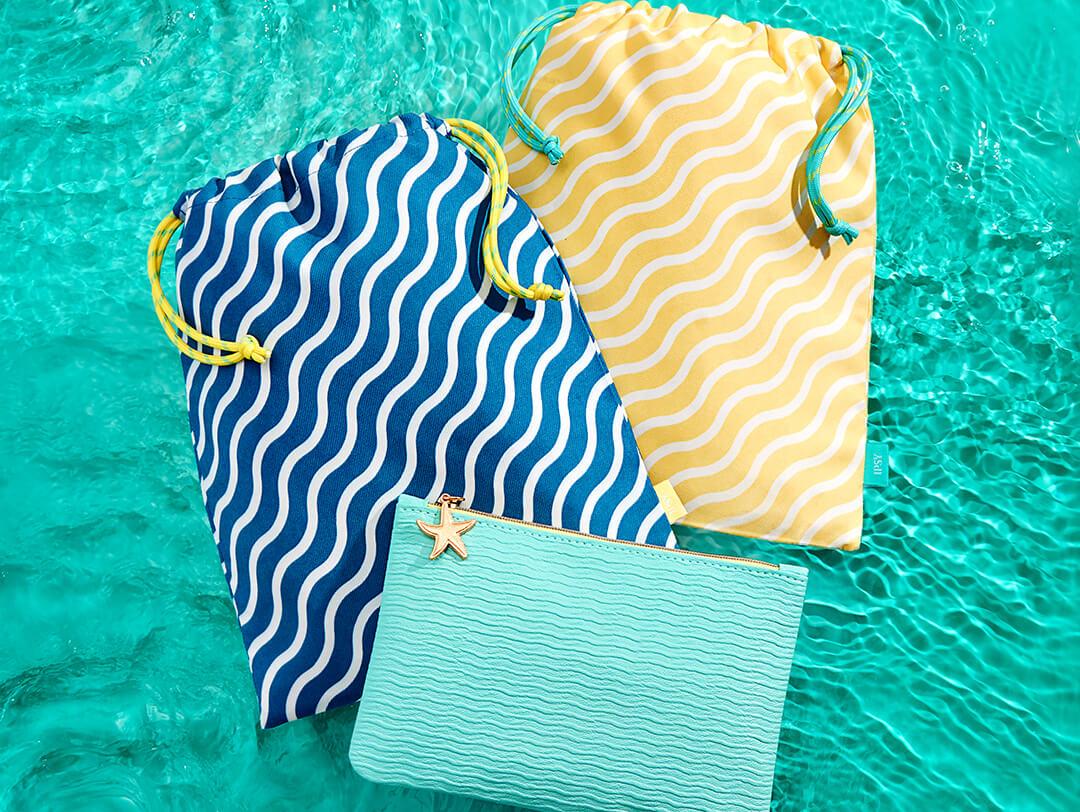 July 2022 IPSY Glam Bag and Glam Bag Plus bags in water Desktop