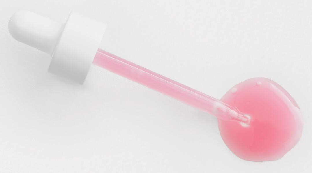 An image of a dropper with pink liquid inside Desktop