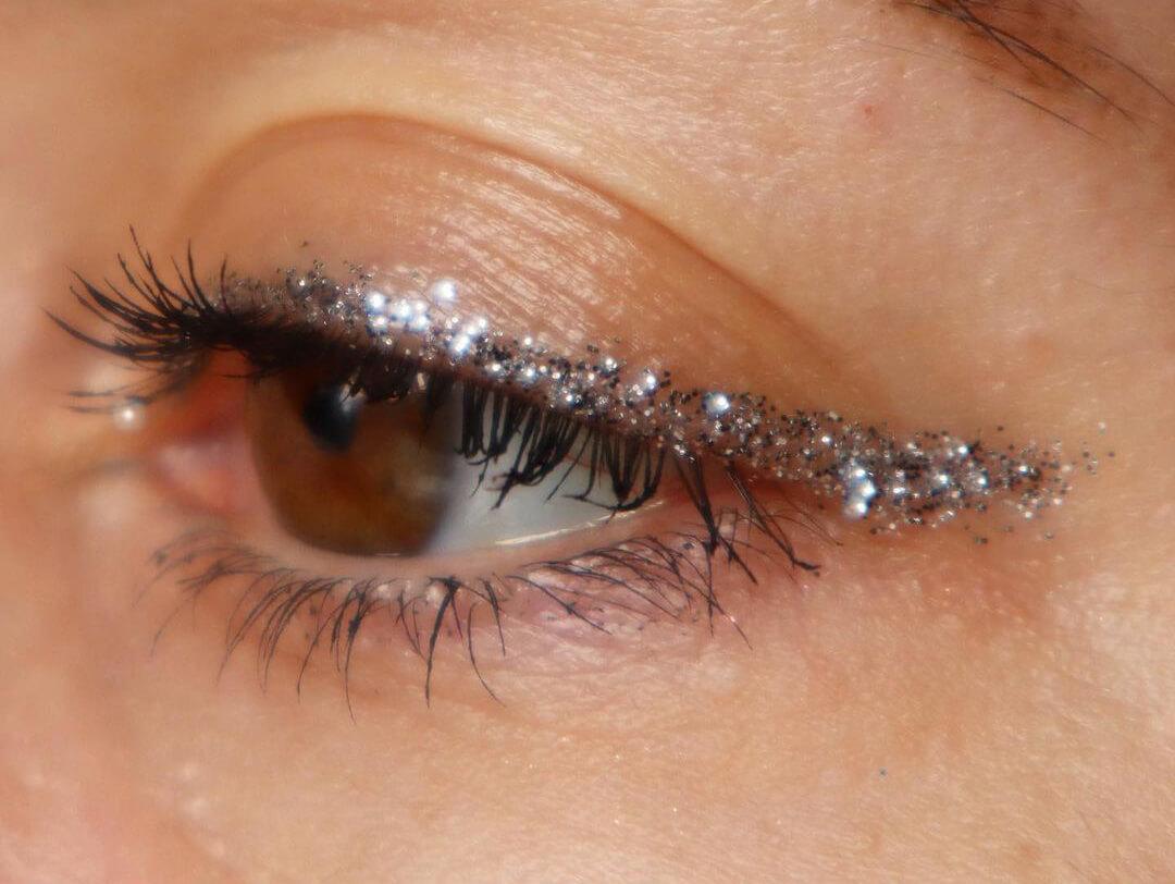 Close-up of a young woman's glitter eyeliner makeup look Desktop