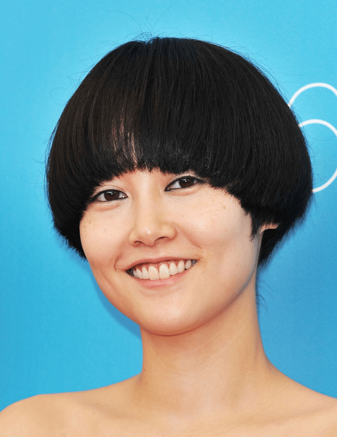 Smiling Rinko Kikuchi rocking a mushroom cut hairstyle Mobile