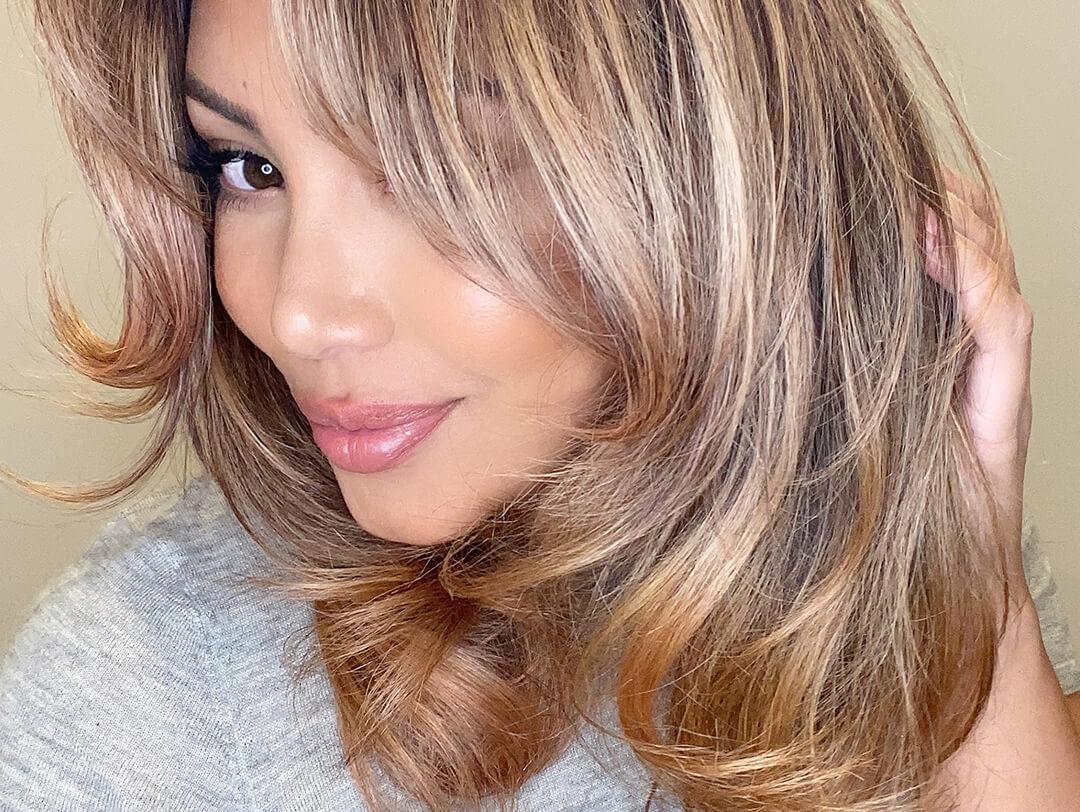 Close-up of Cynthia Alvarez posing and rocking her blow-out hairstyle Desktop