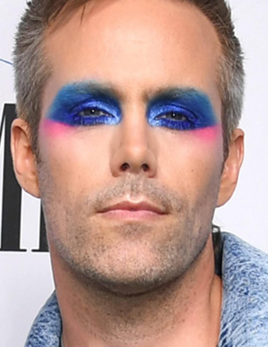 Justin Tranter in bold blue eyeshadow makeup Desktop