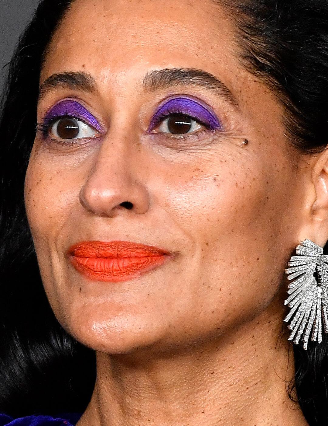Tracee Ellis Ross rocking a matte purple eyeshadow look paired with orange lips Desktop