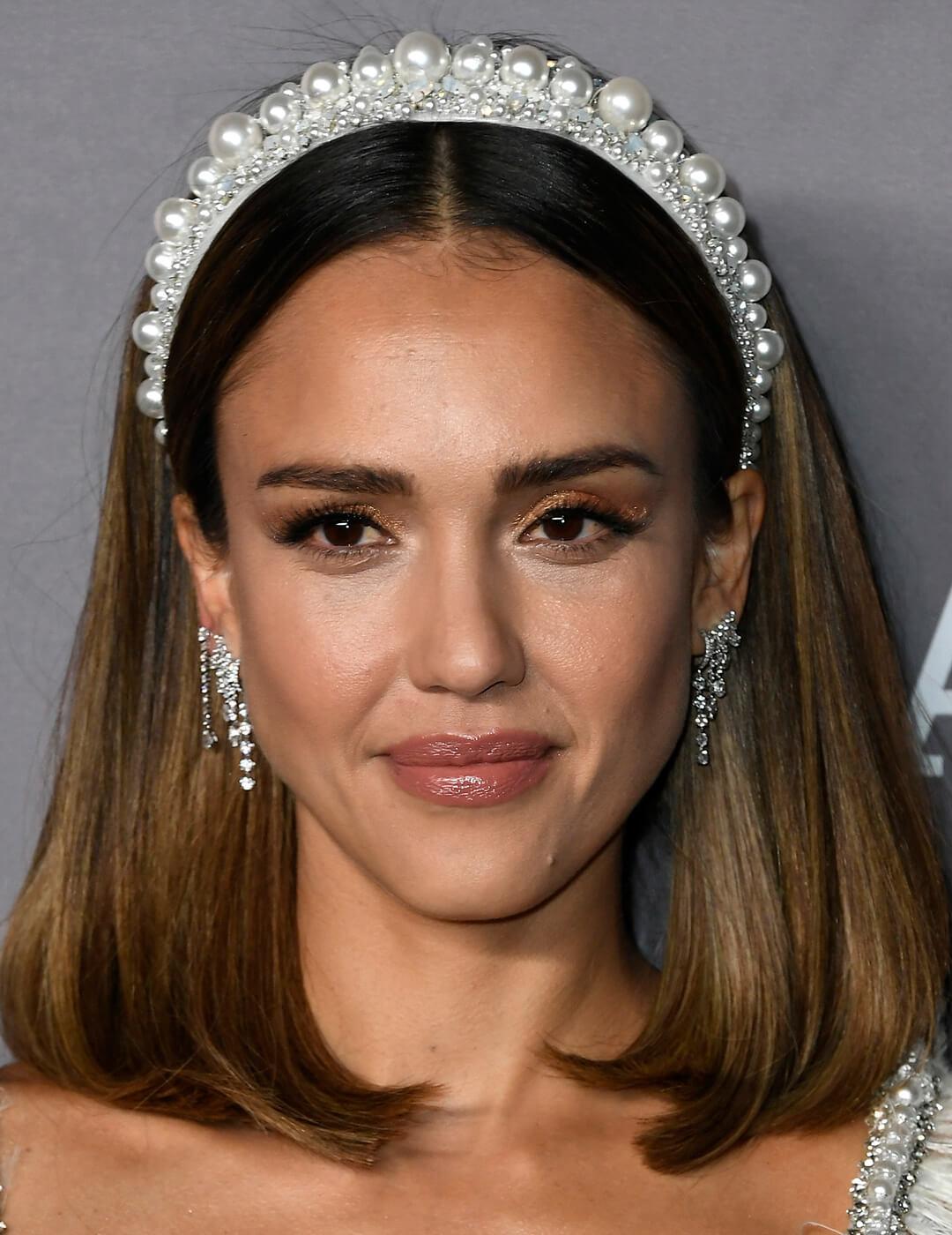 A photo of Jessica Alba showing her shoulder-length dark hair with white crystal headpiece Mobile