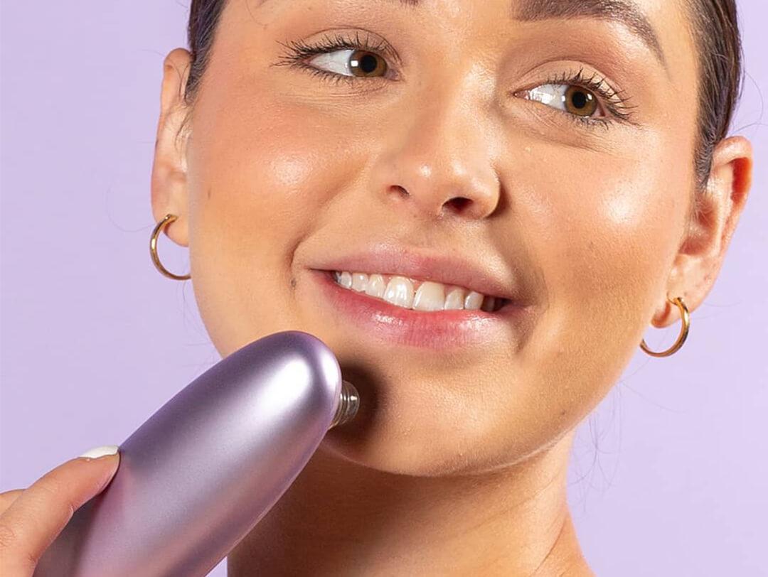 A photo of a model's face using a pore vacuum on her chin Desktop