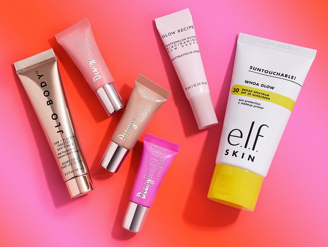 Beauty products from the August 2023 IPSY Glam Bag on gradient pink and orange background Desktop