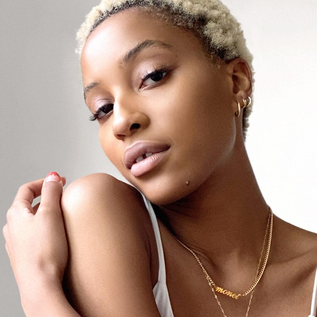 Close-up of a Black model posing and rocking a pink monochromatic makeup look Desktop