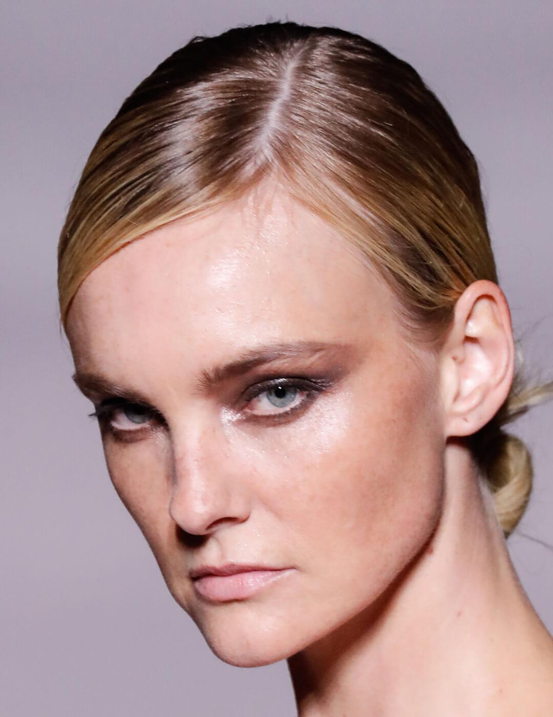 A closeup photo of Caroline Trentini with her hair tied into a bun Desktop