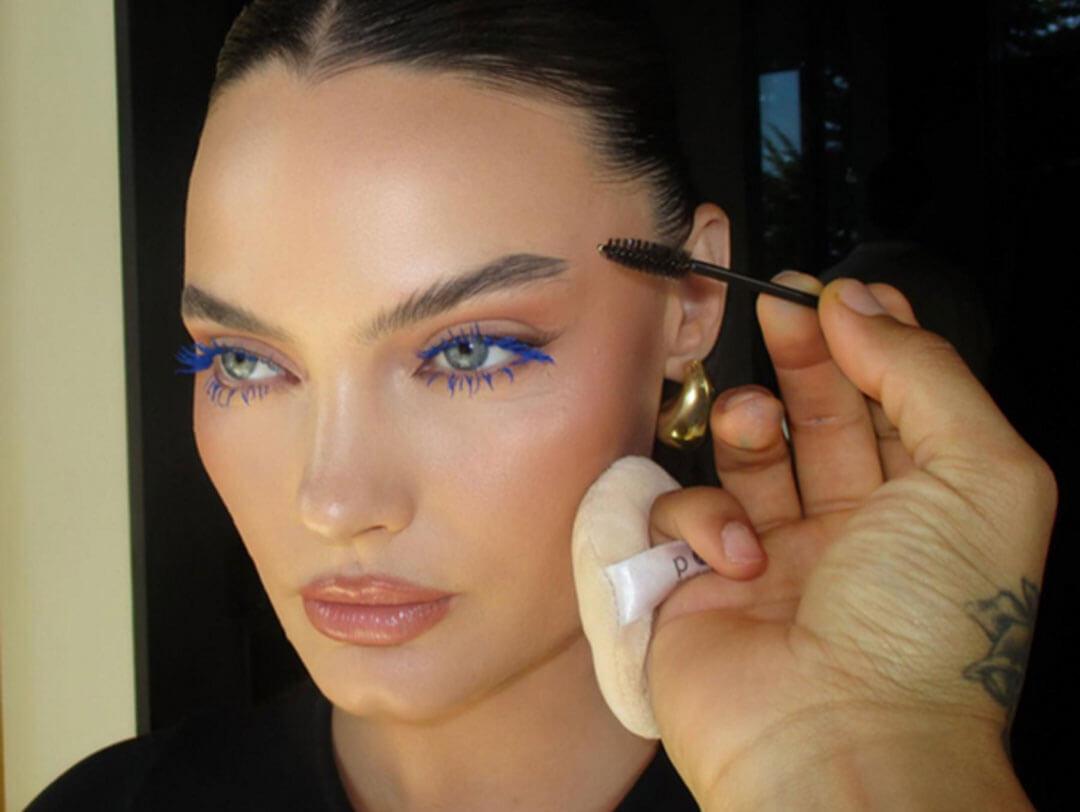 A close-up image of a woman wearing blue mascara and complemented by a nude lipstick Desktop