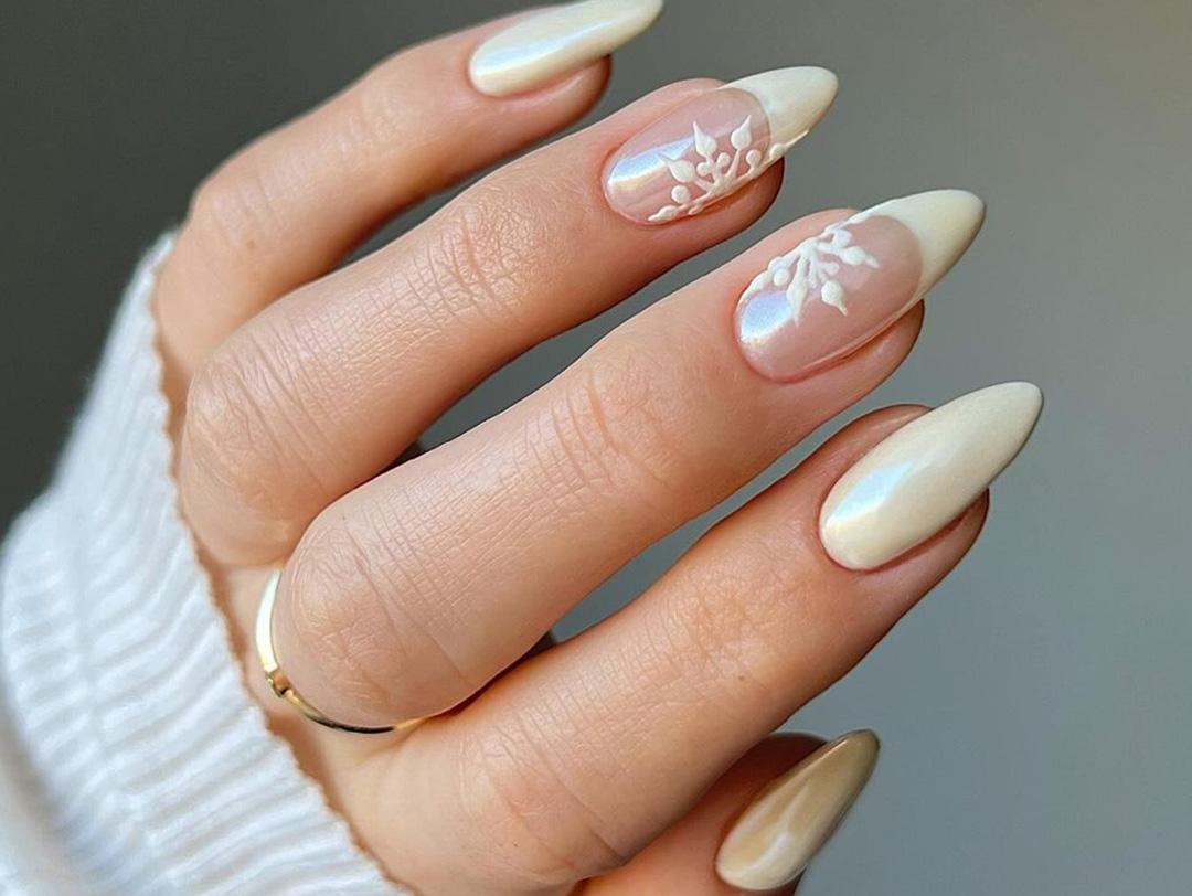 An image of a woman's hand showing her fancy nails with a gold ring on it Desktop