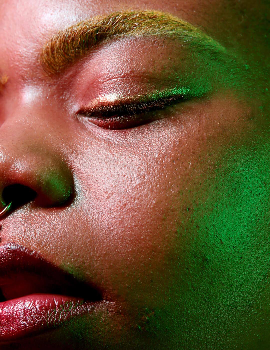 A close-up image of a woman with exosomes, her skin looking confident with her blond eyebrows, clear skin, and a nose earring Desktop