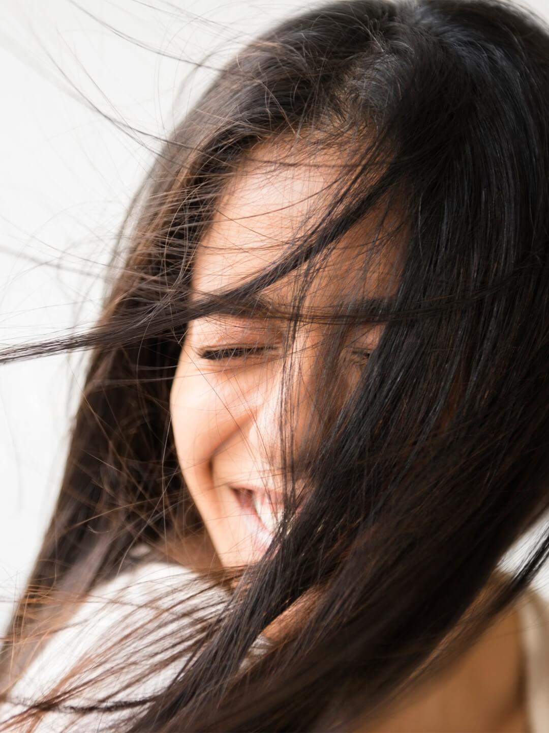 Close-up of a woman with hair blown in the wind Desktop