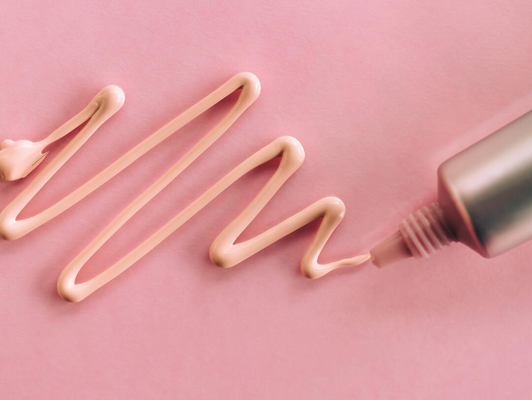 A photo of a concealer swatched on a pink paper Desktop