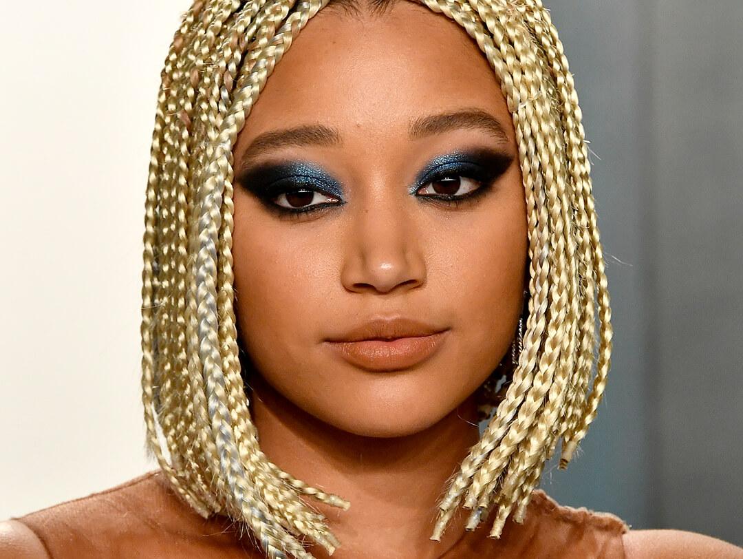 A photo of Amandla Stenberg with gold-colored braided hair and defined smokey eyeshadow Desktop