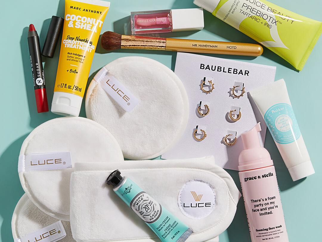 Skincare, makeup, and hair care products, tools, and accessories on mint green background Desktop