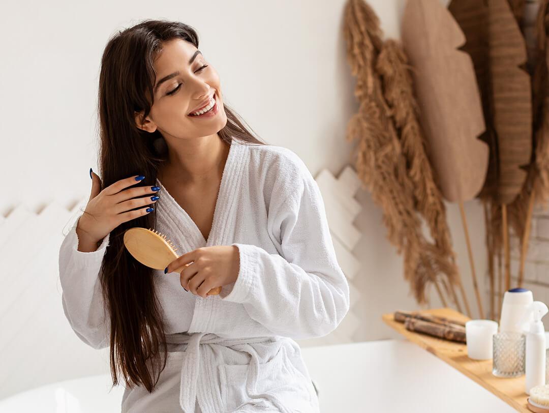 A photo of a woman brushing her hair in the bathroom Desktop