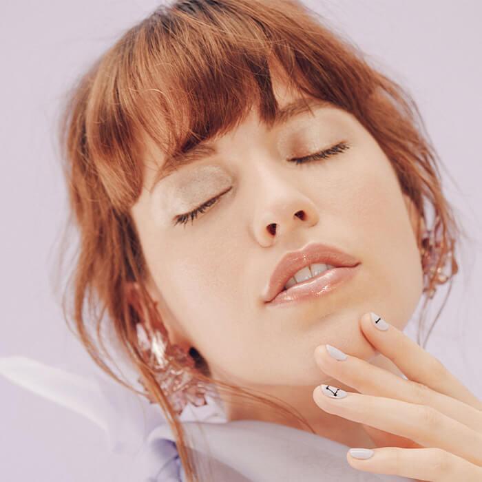 An image of a model with her eyes closed. Mobile