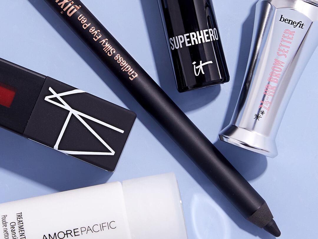 Beauty products from various brands on light blue background Desktop