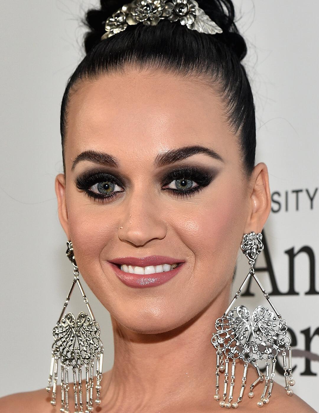 Katy Perry rocking a gradient smoky eye makeup look and silver dangling earrings on the red carpet Desktop