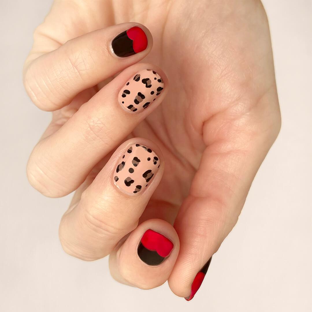 Close-up of a model's hand with nail print and black and red nail art Mobile