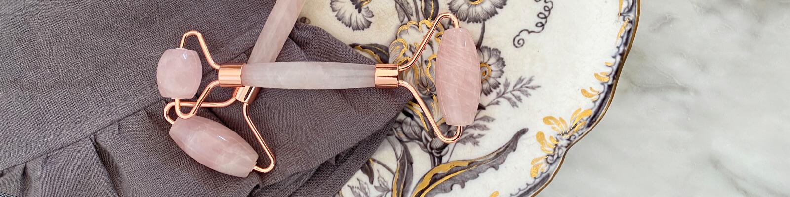 An image of quartz rollers on a plate with intricate floral design and grey piece of cloth Desktop