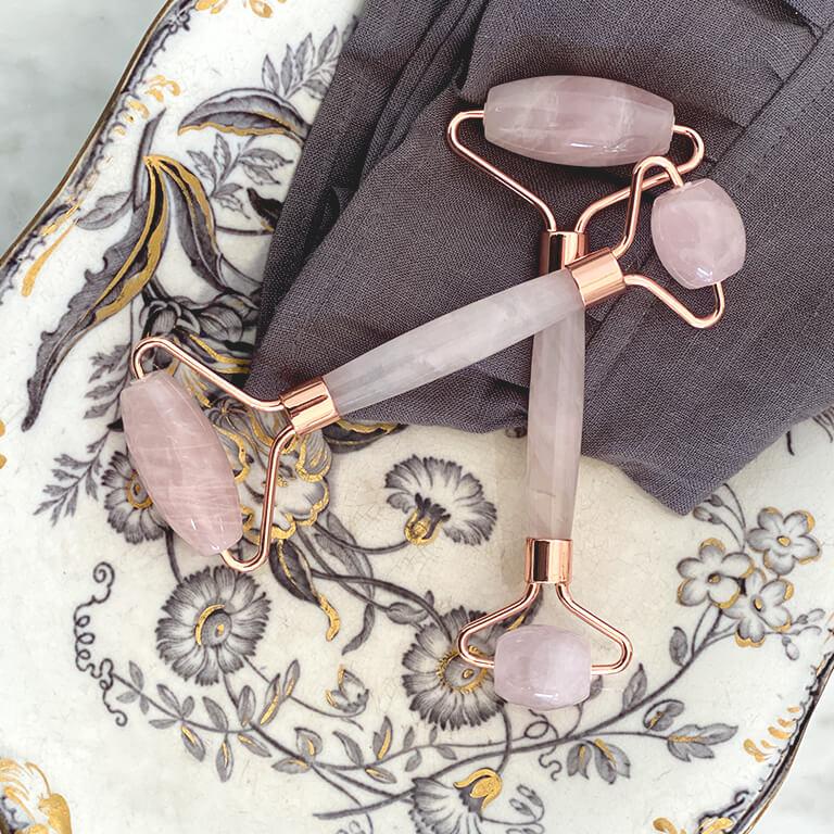 An image of quartz rollers on a plate with intricate floral design and grey piece of cloth Mobile