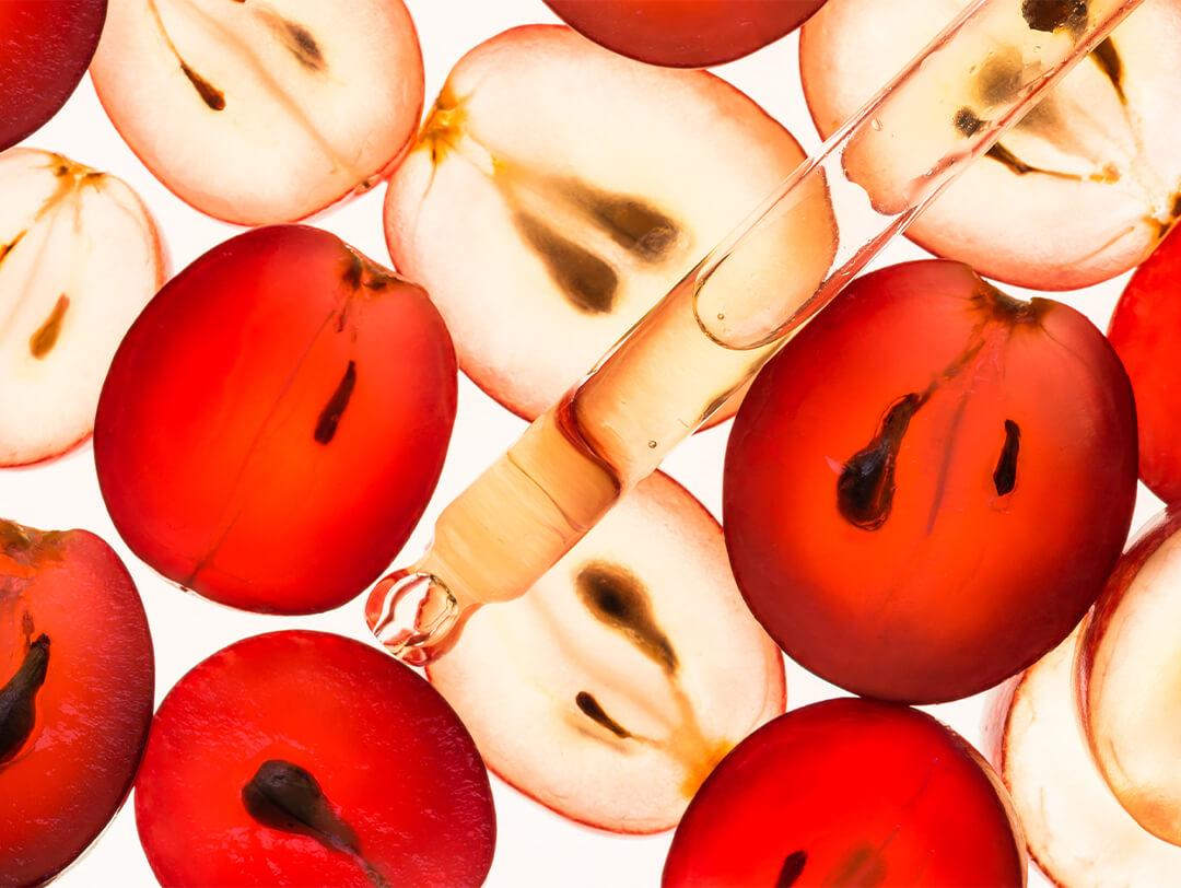 Image of grape halves and dropper with oil inside Desktop