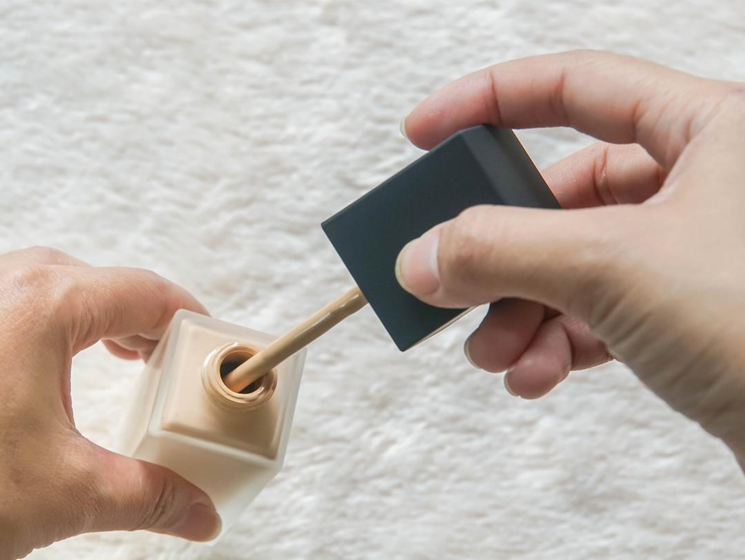 A closeup of liquid foundation and applicator Desktop