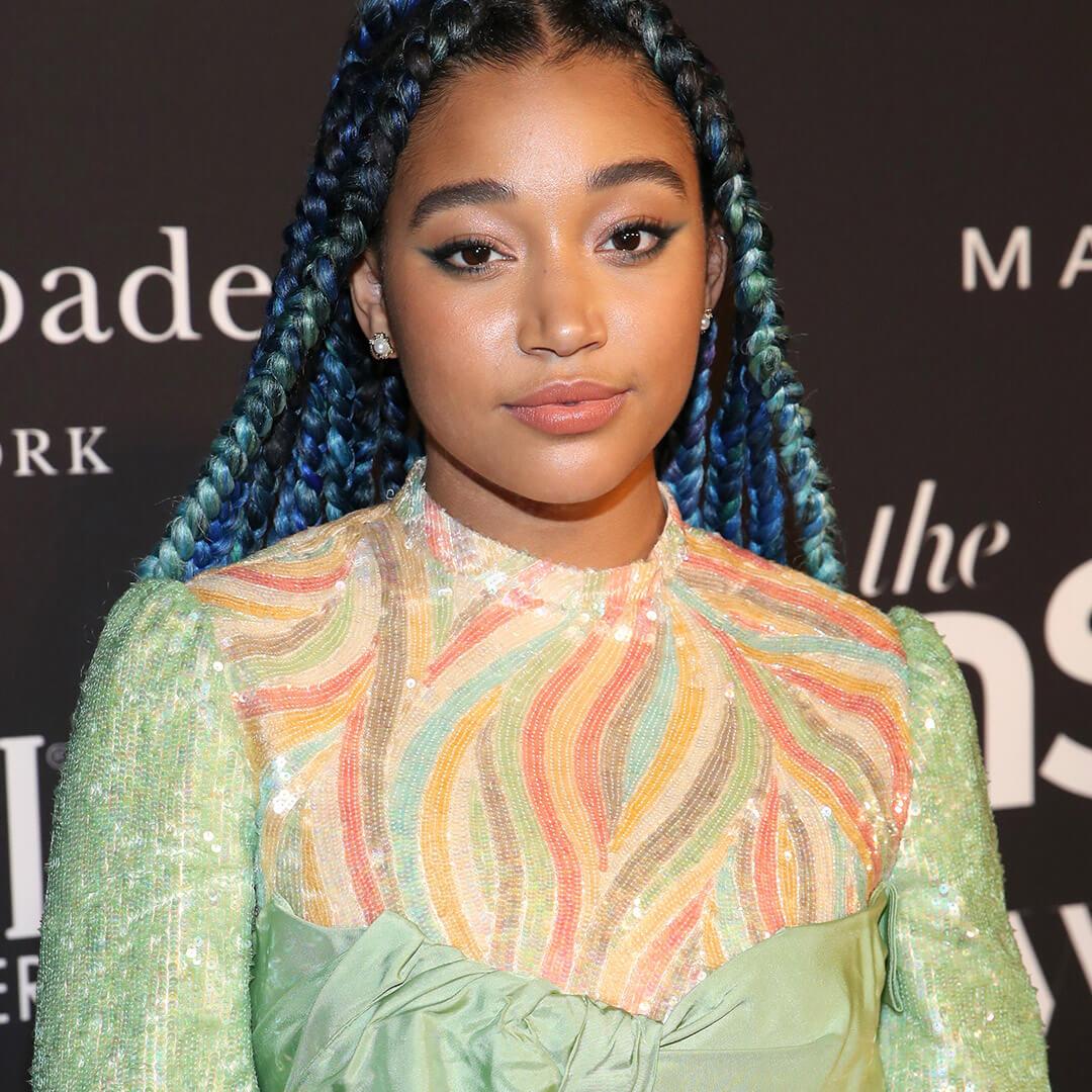 A photo of Amandla Stenberg with blue and teal braids Desktop