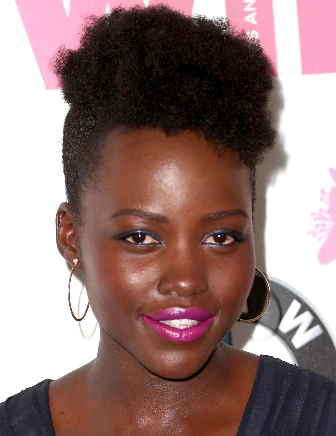 Lupita Nyong'o rocking minimal makeup paired with bold pink lips and her natural curls with undercut hairstyle Mobile