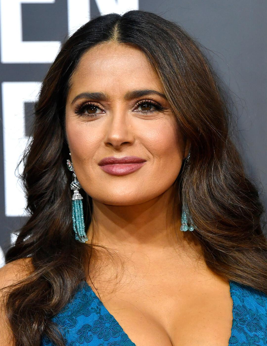 A photo of Salma Hayek with loose wave hairstyle wearing a blue dress Mobile
