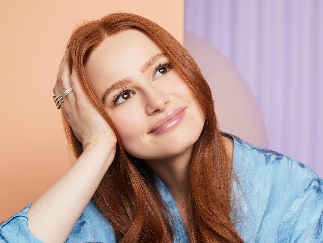 Madelaine Petsch against colorful pastel background posing and looking up Desktop