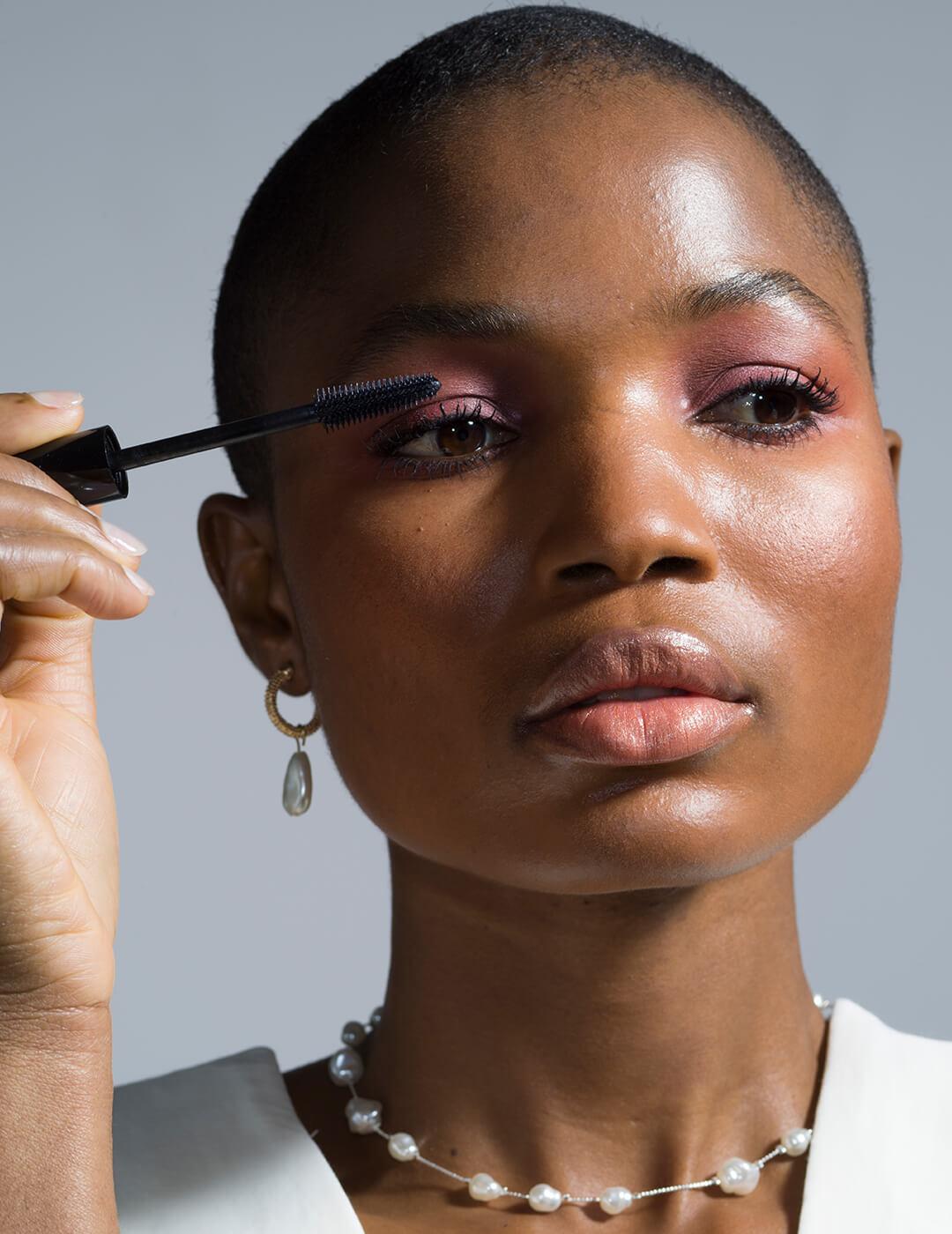 Head Shot Of Model Applying Mascara Mobile